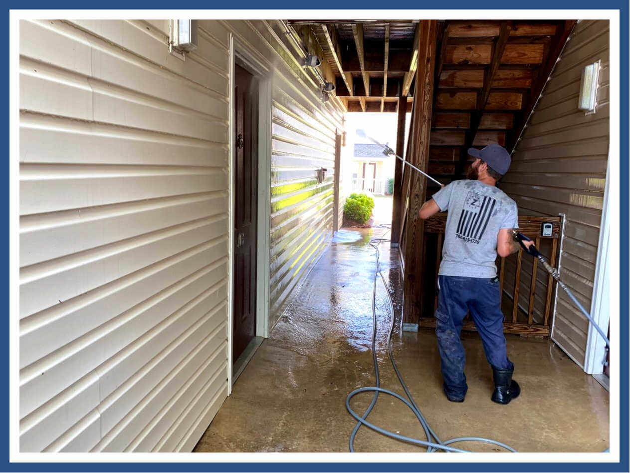 Technician-power-washing-apartment-building-in-charlotte-nc