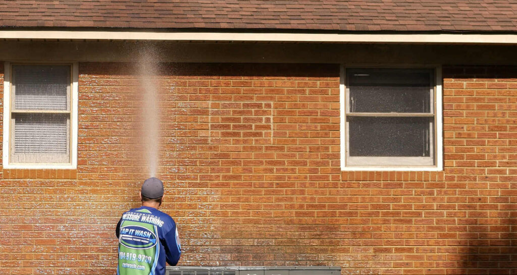 A brick home getting cleaned on the outside.
