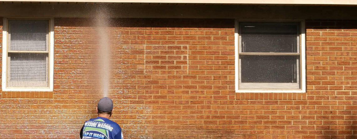 A brick home getting cleaned on the outside.