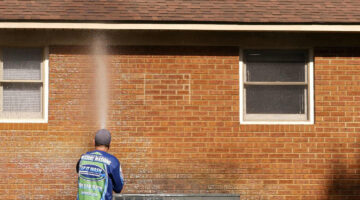 A brick home getting cleaned on the outside.