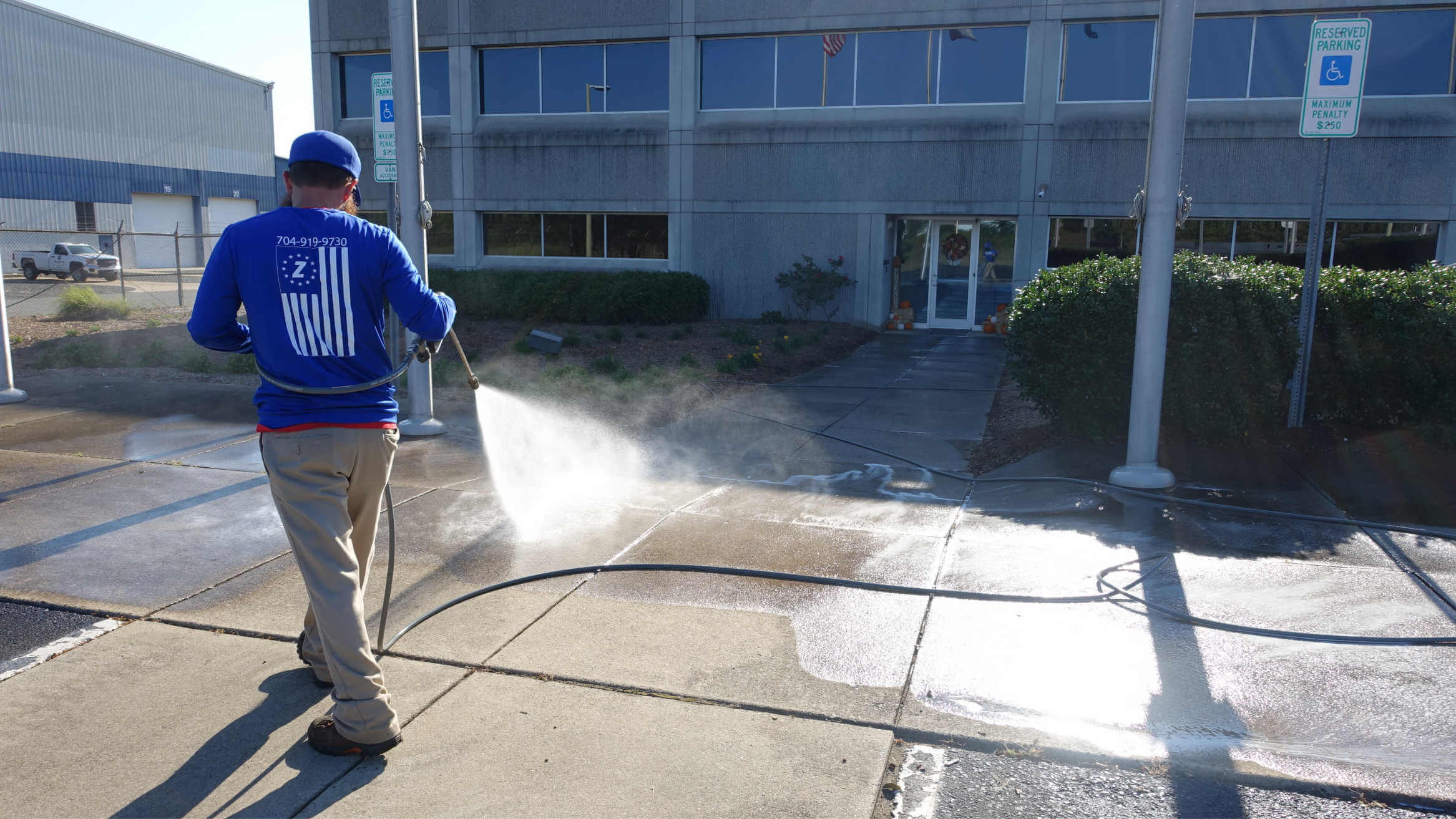 A commercial sidewalk getting pressure washed in Charlotte.